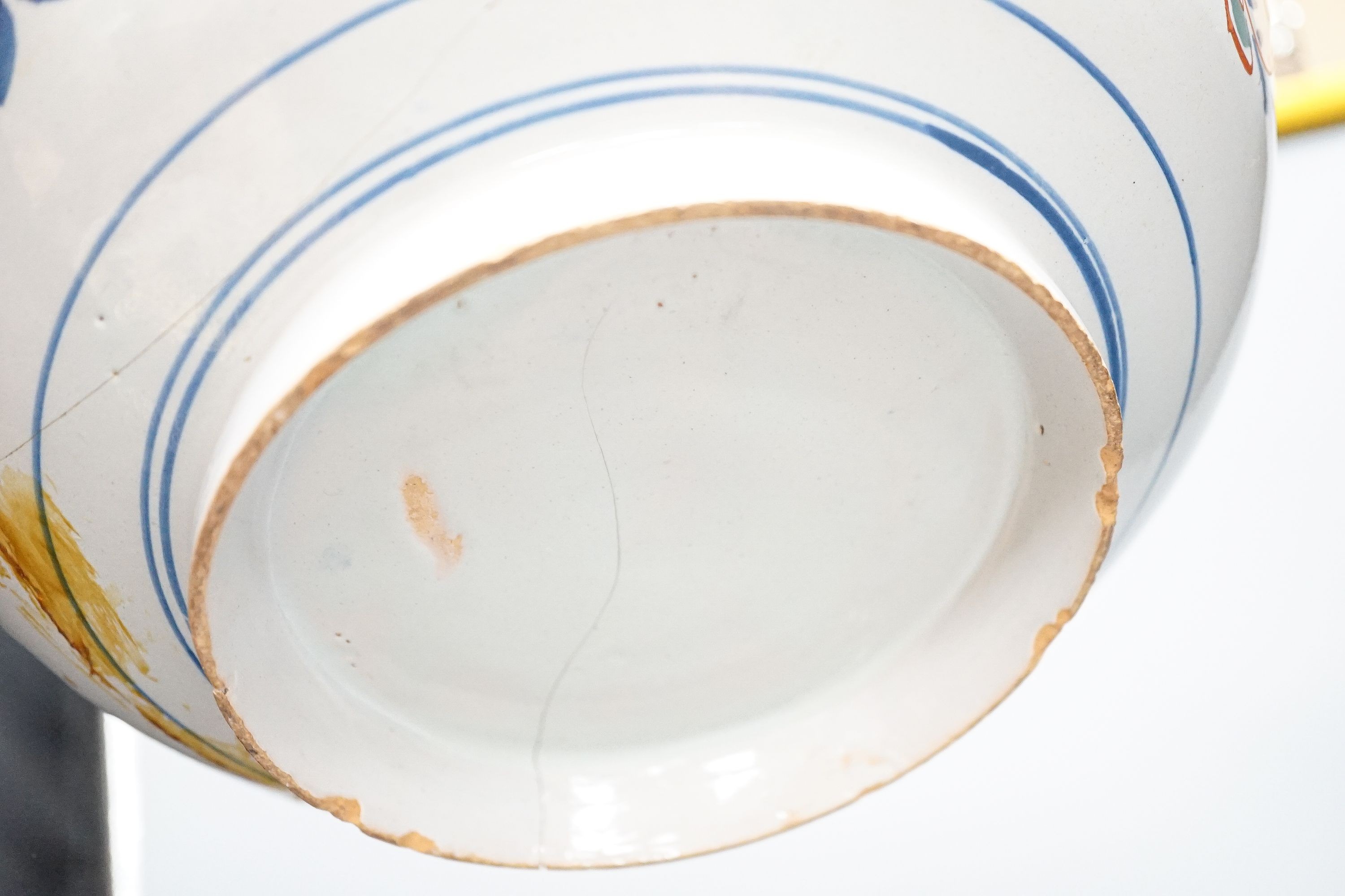 An 18th century English polychrome delftware bowl, interior inscribed 